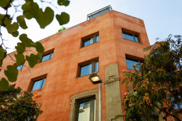 Modern apartment buildings on a sunny summer day. Red Facade of a modern apartment complex. Living house facade with park. Mortgage in real estate