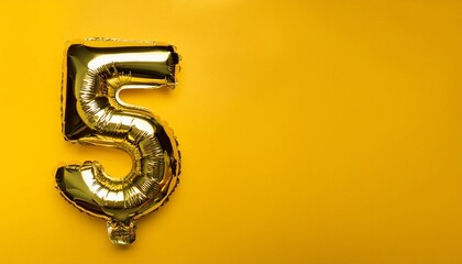 foil holiday number 5 on a yellow background with confetti with space for text, greeting card.
