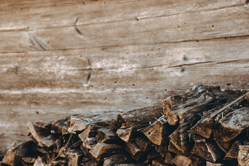 Chopped firewood pile. Woodpile board wall. Wood. Old dry pine wooden heap. Brown color textured background. Natural resources. Rural solid fuel. Winter preparation. Rustic style pattern. Woodworking