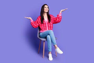Full length photo of charming positive woman wear pink cardigan sitting stool showing arms scales...