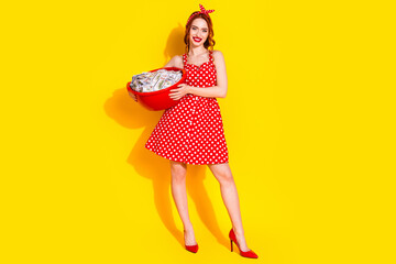 Photo of pretty lovely adorable positive lady washing clothes isolated on vivid yellow color background