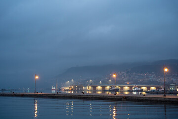 Early morning view on Molo Audace, with illuminated street lantern, Trieste, Italy 03.01.2024