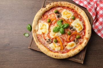 Delicious vegetarian pizza on wooden table, top view
