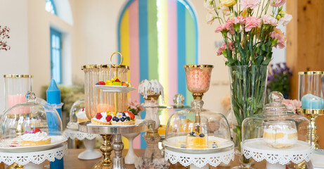 A Sweet Symphony of Delights: A pastel-hued patisserie counter brimming with an assortment of delectable pastries and cakes, bathed in natural light and adorned with fresh flowers.