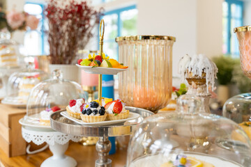 Sweet Treats Buffet: A delightful spread of colorful pastries and fruit platters, arranged on elegant tiered stands, creating a tempting visual feast for any occasion.  