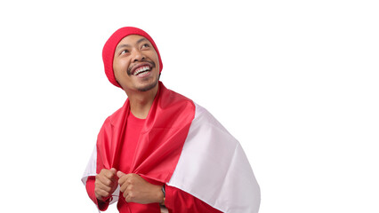 Fototapeta premium Happy Indonesian man wearing a red long sleeve T-Shirt and a red beanie hat holds Indonesia's flag to celebrate Indonesia Independence Day on August 17. Isolated on a white background.