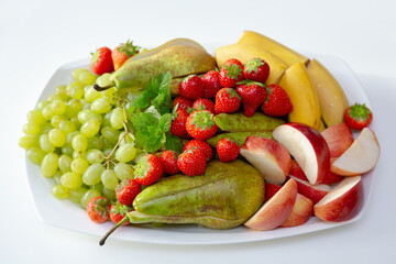 a plate of various fruits and berries