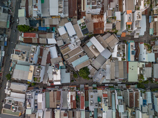 Ho Chi Min City, Vietnam District eight from top down aerial view featuring  rooftops, dense urban housing, streets and alleyways.