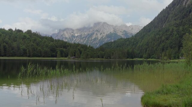 Tranquil mountain lake with German Alps in background, Ferchensee Germany