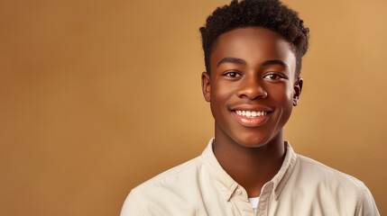 Portrait of a happy cheerful serious, troubled African American teenager guy with perfect skin, brown background, banner.