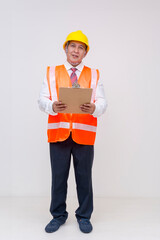 Whole body photo of a middle aged asian construction project manager or engineer in a safety helmet and vest holding a clipboard. Isolated on a white background.