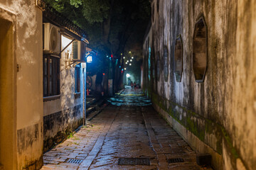 Obraz premium old buildings and neighborhood at night,light design,street shop