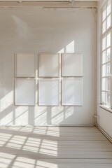 Fototapeta premium Minimalist art gallery featuring empty frames on a bright wall.