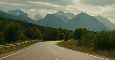 Two motorcyclists taking break on winding mountain road