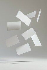 A dynamic composition of floating blank white cards against a soft gray backdrop.