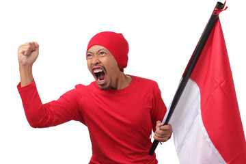 Indonesian man wearing a red long sleeve T-Shirt gives a speech while holding an Indonesian flag and raising his fist in celebration of Indonesia's Independence Day on 17 August, on white background