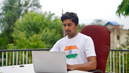 Indian smart man doing office work at home using laptop.