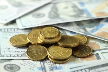 Many euro coins on dollar banknotes, closeup