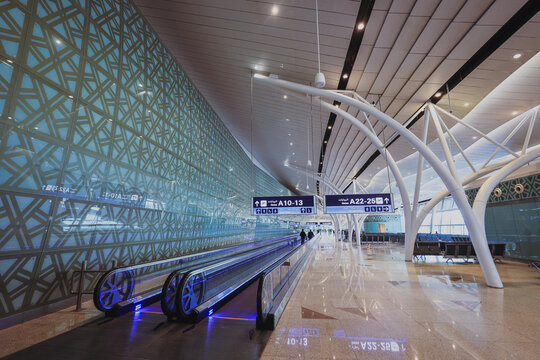 Jeddah, Saudi Arabia - April 29, 2024: Modern interior of Jeddah Airport Terminal showcasing walkways, signs, and unique architectural design