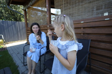 Fototapeta premium Mother and a child eating ice cream at home