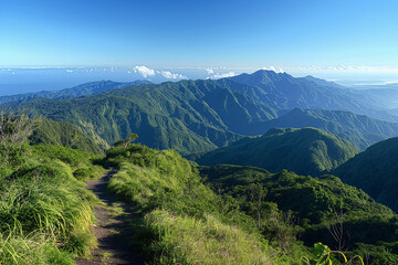 Obraz premium A breathtaking view of a mountainous landscape with rugged peaks and lush green valleys. A winding trail meanders through the scenery, inviting hikers to explore and experience the natural beauty.