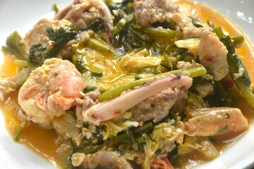 fried seafood with chicken and pork meat couple vegetable tooping egg yolk in sukiyaki sauce on plate