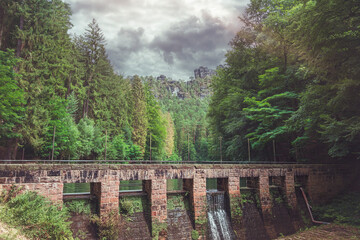 Staumauer Amselsee in the Elbsandsteingebirge surrounded by lush greenery