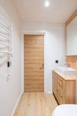 Bright Elegant Modern Minimalist Bathroom Interior Design of White Sink and Toilet. Bathroom Accessories, Pink Color Walls, Mirror, Faucet. LED Light. Wooden Door.