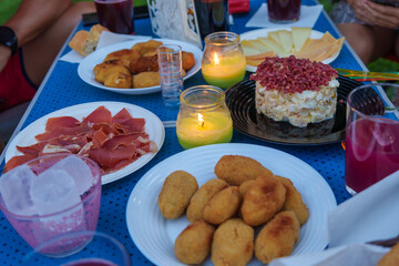 Close-up of Picnic Food and Candles on Table
