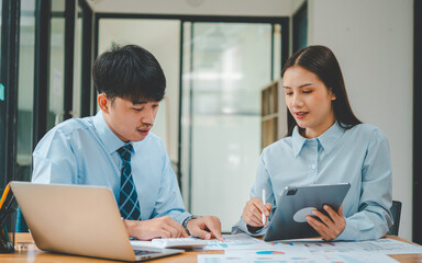 group of business people working and communicating together in the office With the charging of graphs for analysis, conceptual analysis and business planning