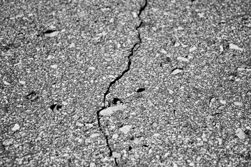 Cracked asphalt pavement. Cracked asphalt,road,highway,road shoulder,roadway damage. Emergency condition of the asphalt, damage.