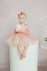 little girl in a dress with cake
