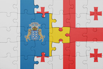 puzzle with the colourful national flag of georgia and flag of canary islands.