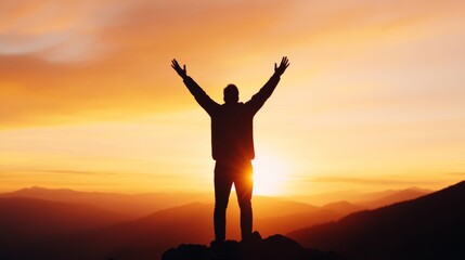 Fototapeta premium Silhouette of a person with raised arms, worshiping at sunrise on a hilltop, with a radiant sky in the background 