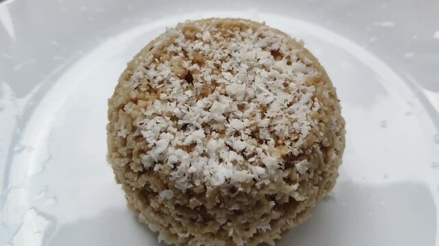 Steamed wheat brown rice cake, puttu, pittu or putt popular traditional native vegetarian dish for breakfast and dinner in the south Indian states of Tamil Nadu and Kerala. Close up macro top view.