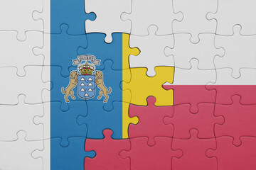 puzzle with the colourful national flag of poland and flag of canary islands.