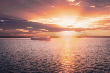 Fototapeta premium Stockholm, Sweden. Tourist Ship Or Ferry Boat Boat Liner Floating Near Islands In Summer Evening. Beautiful Seascape In Sunset Sunrise Time. Sun Sunshine Above Islands Archipelago
