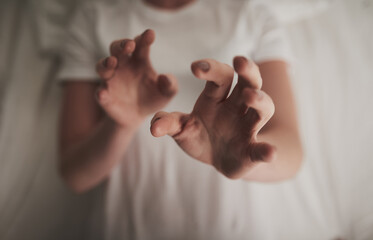Above, hands and person with lying in bed for at home for defense, support and help. Sleeping,...