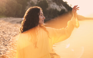 Fototapeta premium Beautiful young woman in the sun rays