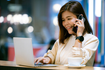 A young East Asian female adult looking and using her mobile phone stock photo