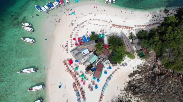 Aerial view of Koh Khai nok or Khai nai island, Thailand. Small island, island cafe, snorkeling, Phi Phi islands tour. Moored boats, turquoise clear water. High quality 4k footage