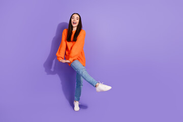 Photo of crazy funky nice pretty girl wear trendy orange clothes empty space isolated on purple color background