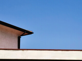 Building Roof Architecture Against Blue Sky: Negative Space.  Minimalism. Place for your text, business concept.