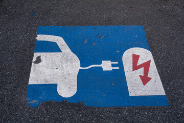 Oregrund, Sweden An electric car charging symbol on the pavement.