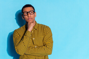 Photo portrait of pretty young male look skeptical think empty space wear trendy plaid outfit...
