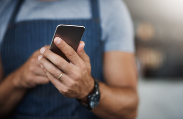 Cafe, waiter and hands of man with phone for online order, communication and restaurant app update. Small business, worker and technology at coffee shop for web, sales and digital hospitality service