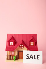 Classic house model on sale on pink background. Top view