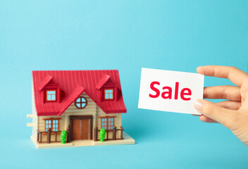 Classic house model on sale on blue background. Top view