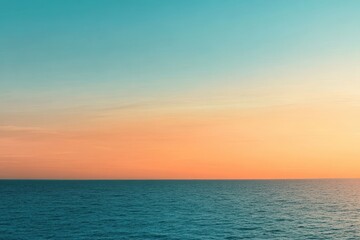 Obraz premium A gradient moving from a warm orange to a cool teal with a subtle grain effect, resembling a sunset over the ocean.