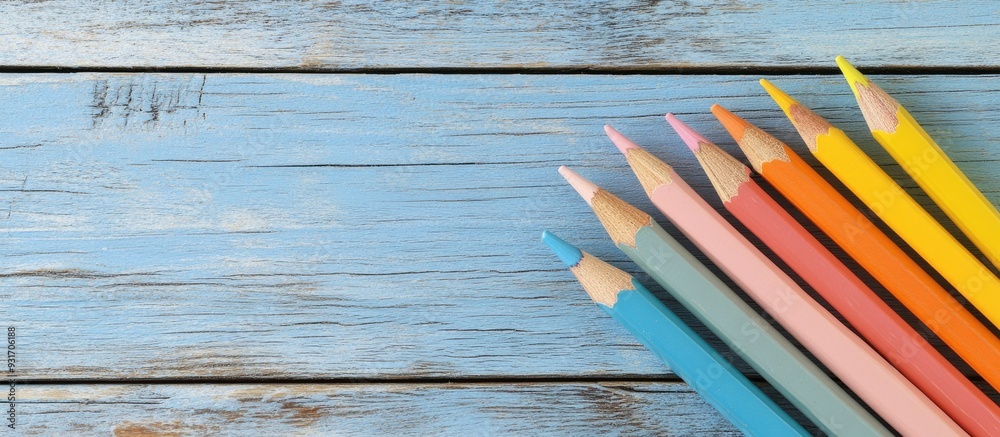 Poster pastel colored paper and pencil on a rustic wooden background creating a minimalist back to school c